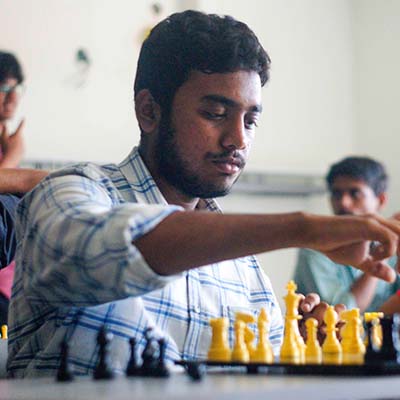 Ashwatthama '23 contemplating his next move during a chess game, demonstrating foresight and strategic thinking.