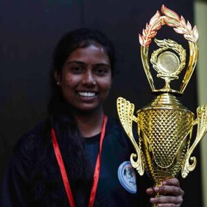 Ashwatthama '23 holding his trophy, celebrating his victory at the Golden Glory event.