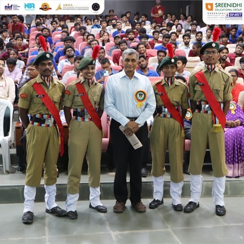Dr Jayaprakash Narayana humbly poses with NCC cadets, being honored by their presence.